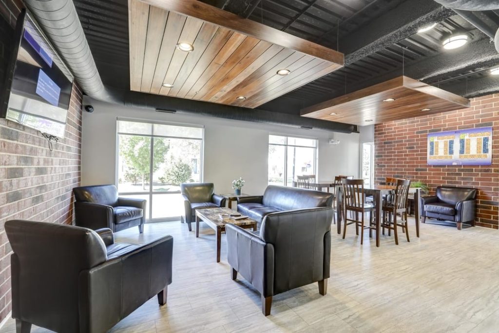Interior photo of lounge with sofa chairs and table