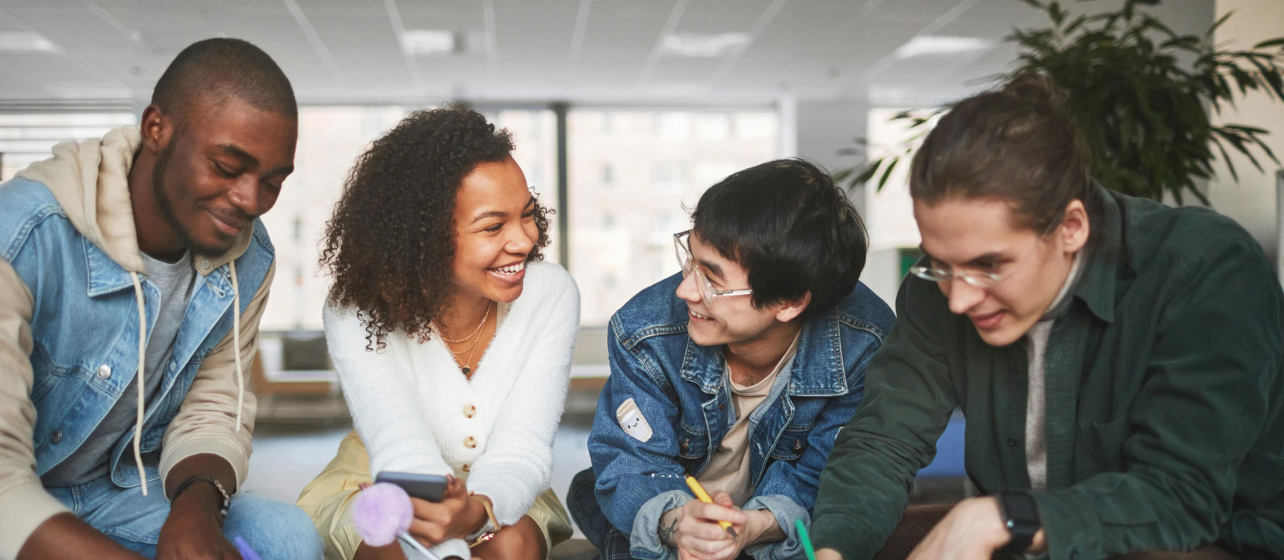Photo of four college-aged students studying together
